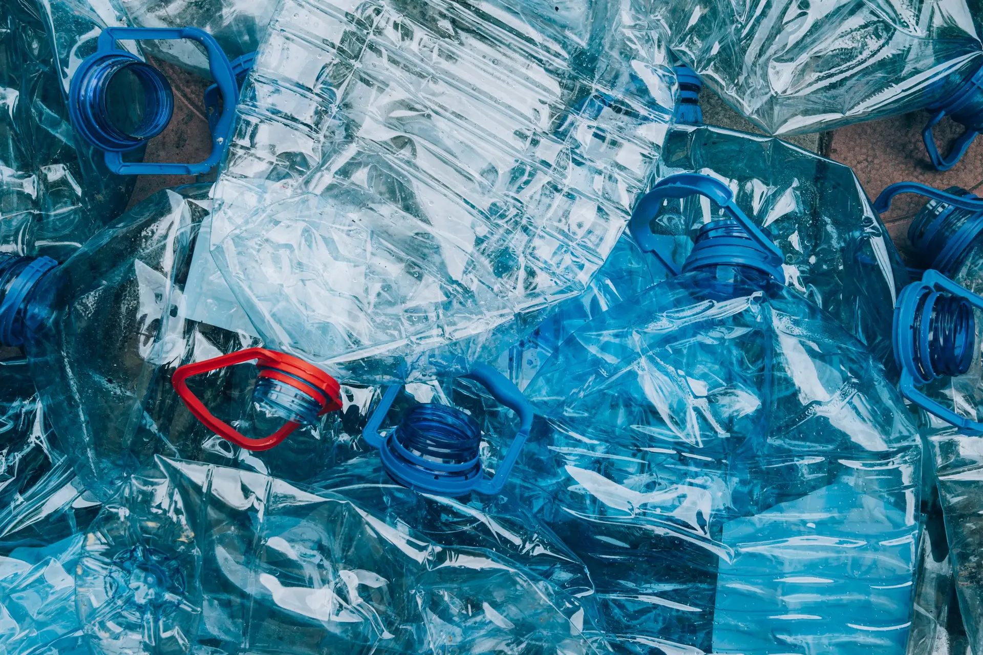 Top view of an empty used blue plastic bottle