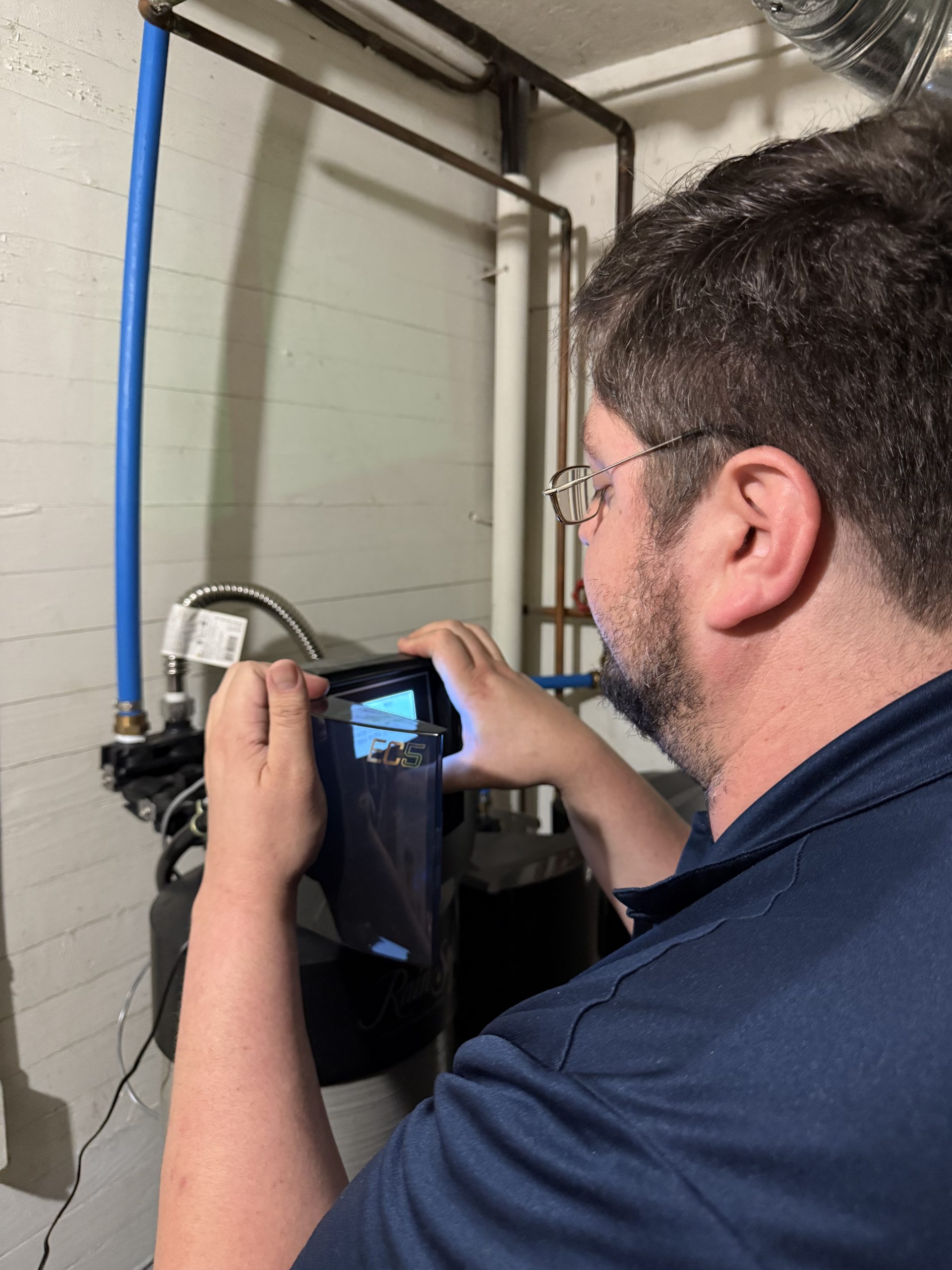 Technician servicing water system