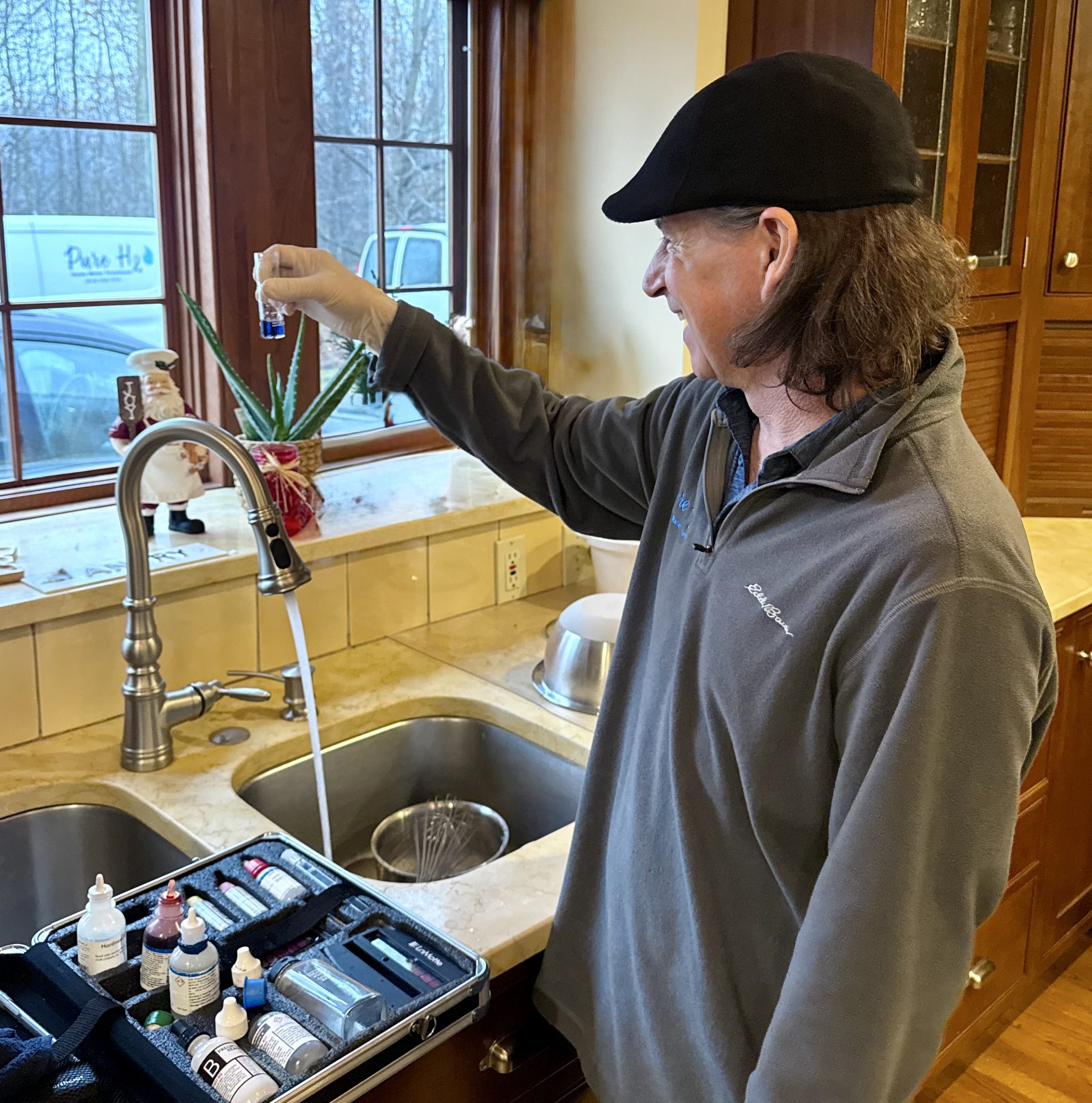 Pure H2O specialist running a free in-home water test at a customer's kitchen sink in Ohio