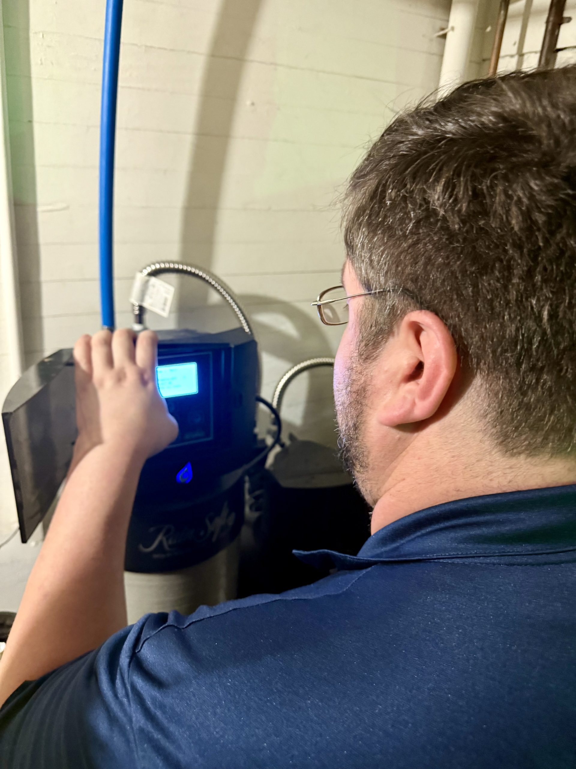 Pure H2O technician servicing water treatment equipment